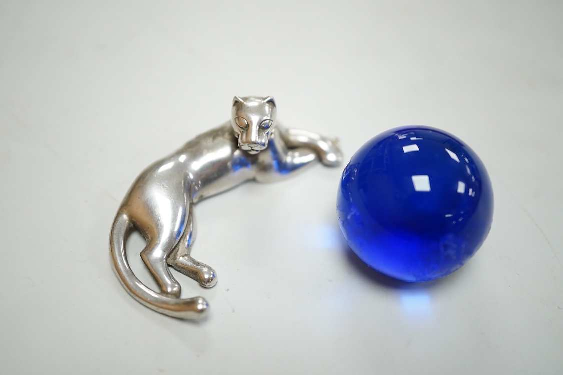 A recent Cartier paperweight, modelled as a recumbent 925 panther with blue glass sphere(a.f.), signed, in original fitted Cartier box, 56mm by 60mm.